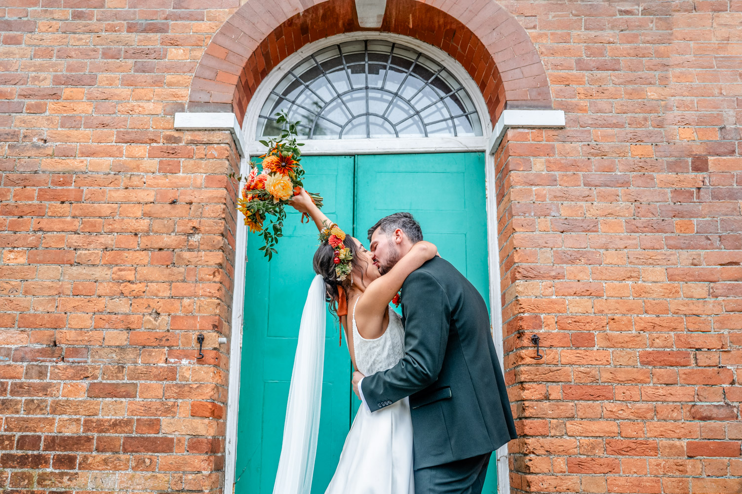 bride and groom under a colourful cloud of confetti old bull Hurley wedding photographer