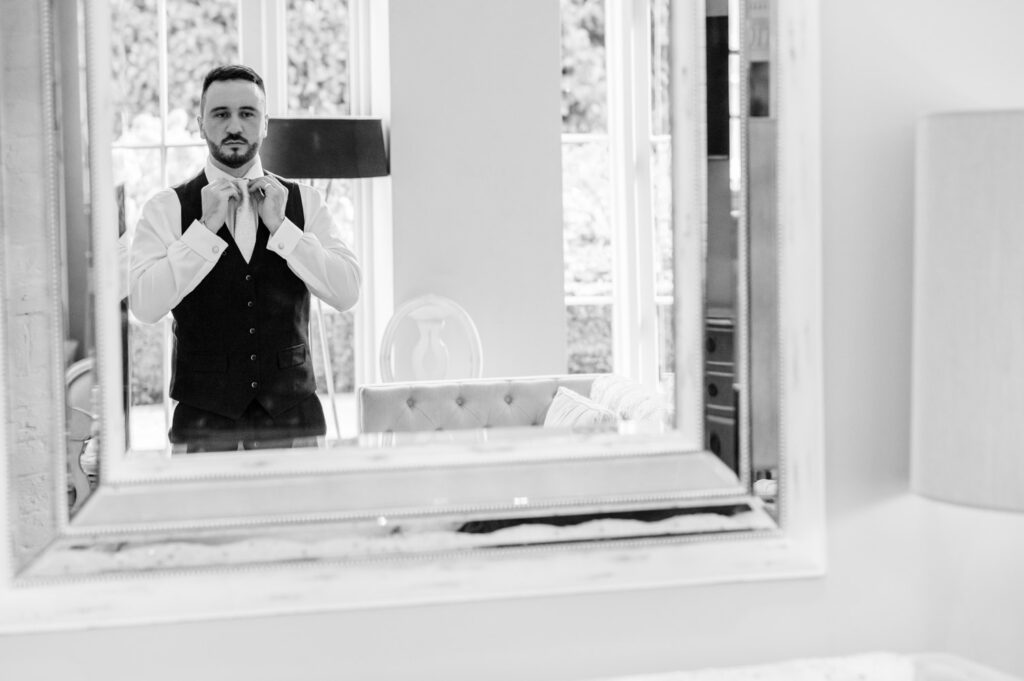 Groom adjusting tie 