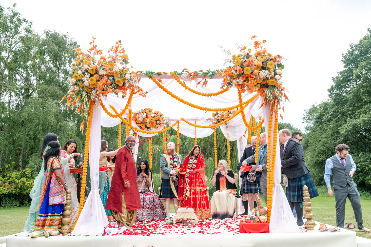 bride and groom under a colourful cloud of confetti old bull Hurley wedding photographer