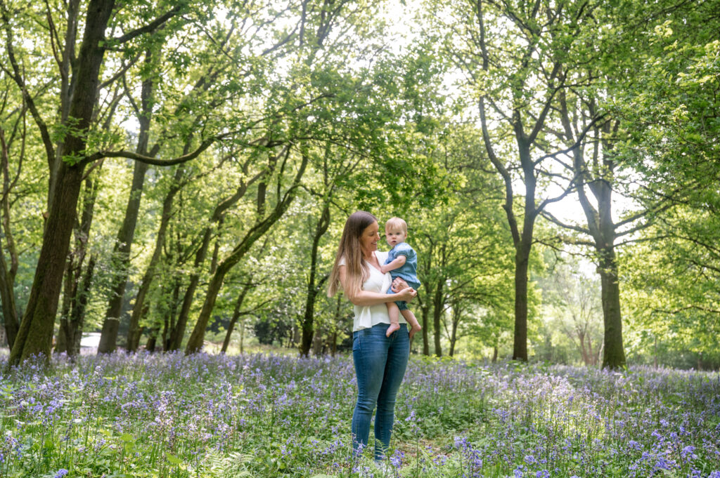 mum and baby in bluebell woods