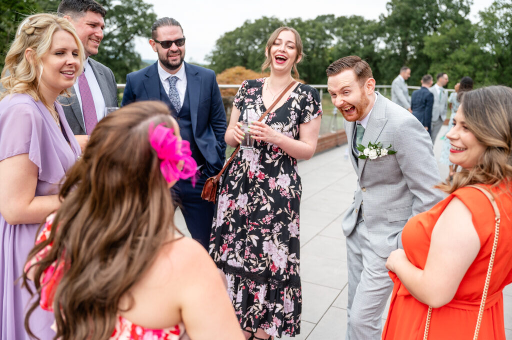 wedding guest laughing with the groom