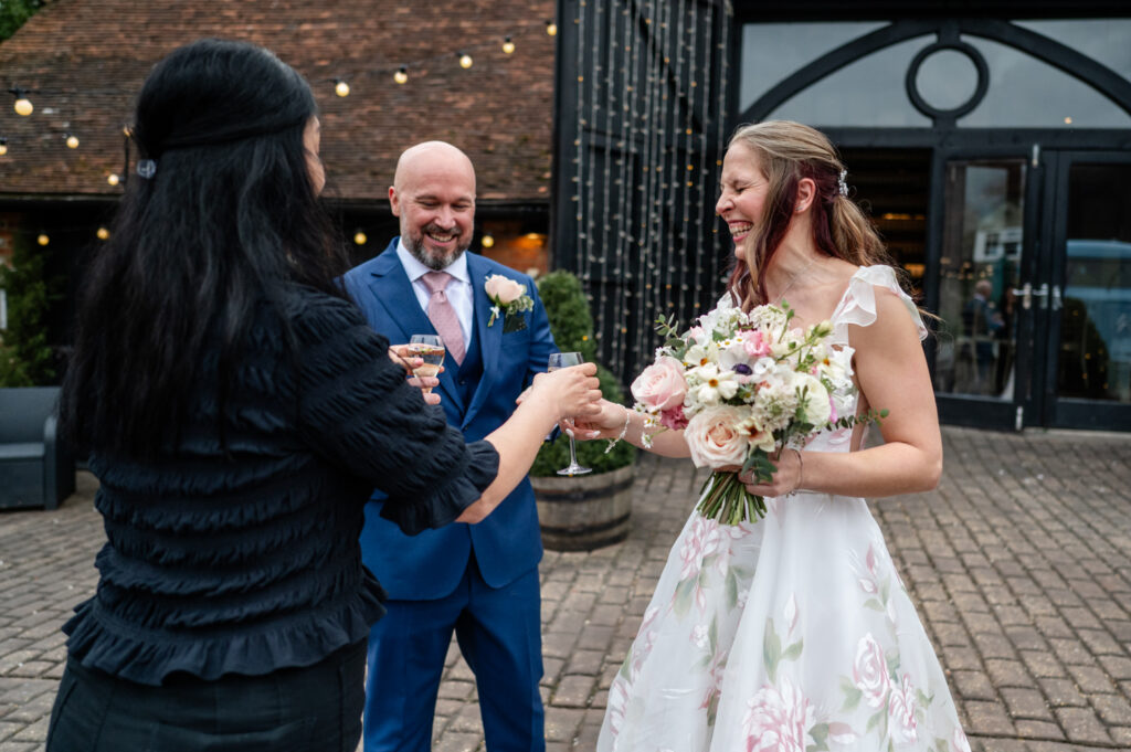 Kristin and Simon enjoying their first champagne together as newlyweds during their intimate Old Luxters Barn micro-wedding elopement.