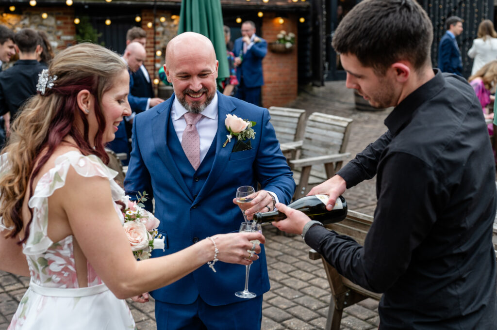 Kristin and Simon enjoying their first champagne together as newlyweds during their intimate Old Luxters Barn micro-wedding elopement.