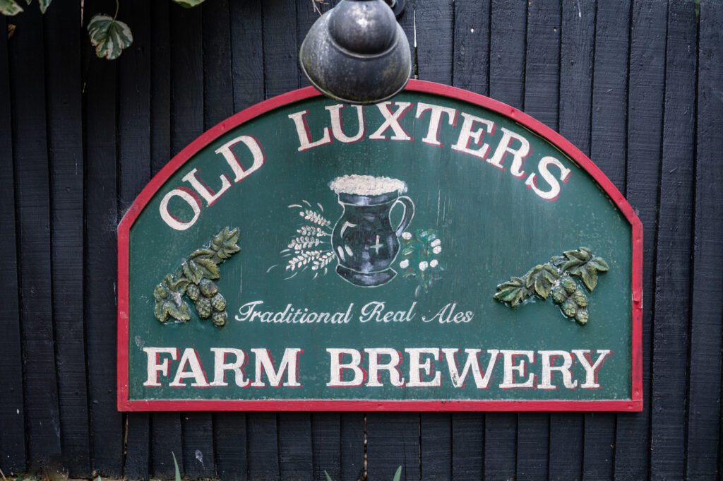 Signage at Old Luxters Barn showcasing the rustic charm of the venue for Kristin and Simon’s micro-wedding elopement.