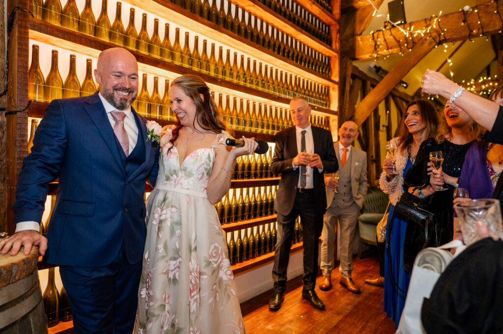 A touching moment as Kristin and Simon share a toast during their micro-wedding elopement at Old Luxters Barn.”