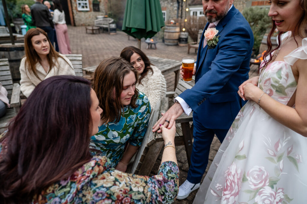 Kristin and Simon showing their wedding rings during their micro-wedding elopement at Old Luxters Barn.