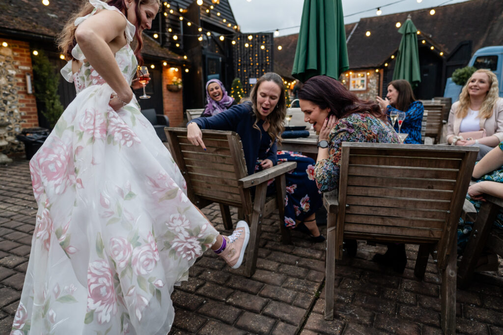 A playful shot of Kristin's Converse trainers during their intimate and casual micro-wedding elopement at Old Luxters Barn.