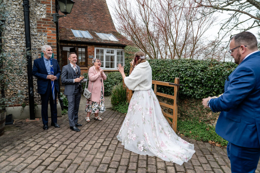 Kristin waving at guests during their intimate Old Luxters Barn micro-wedding elopement