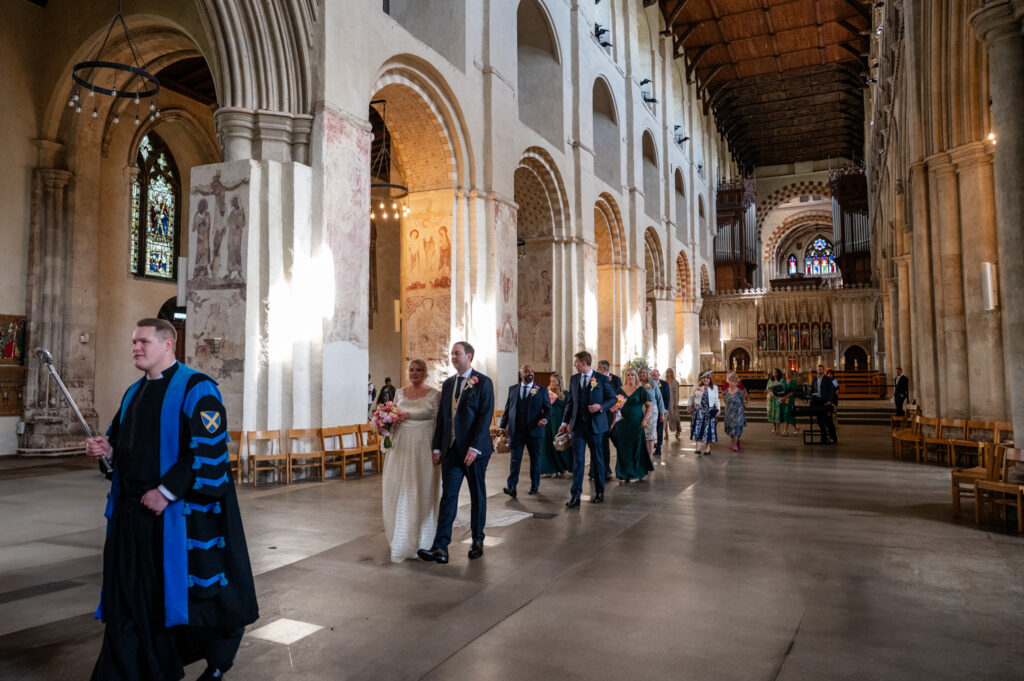 Procession of guests walking through the nave at St Albans Cathedral after the ceremony.