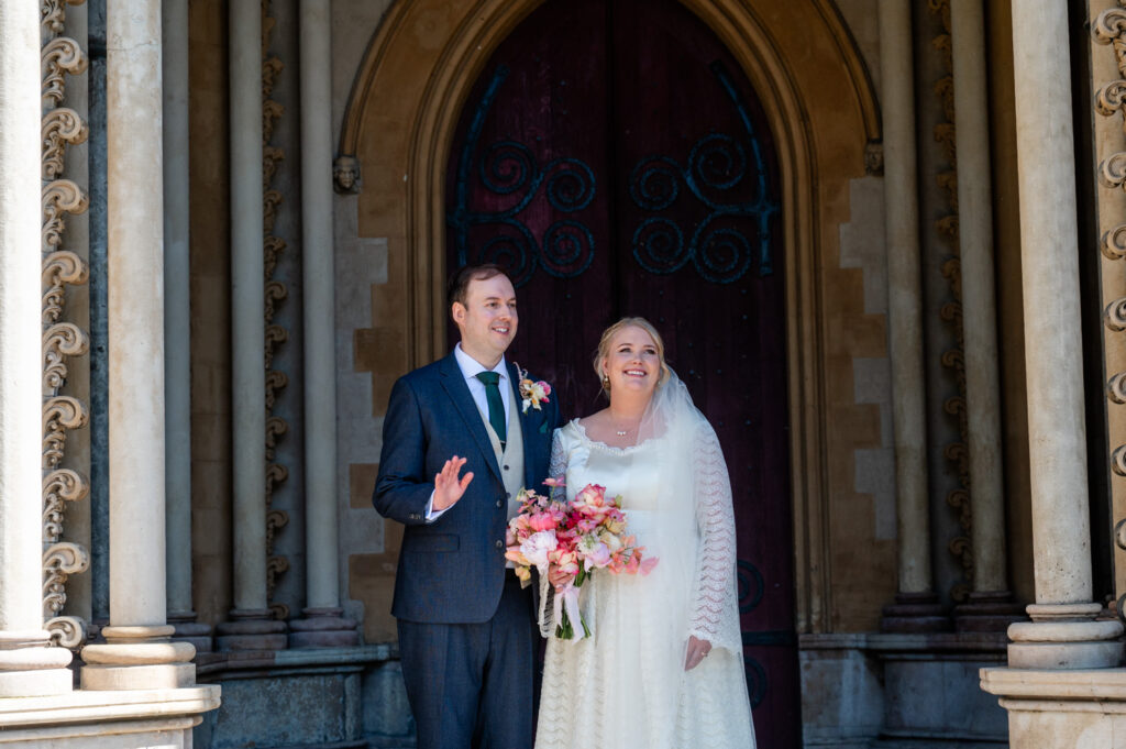 Bride and groom standing together outside St Albans Cathedral after their ceremony.