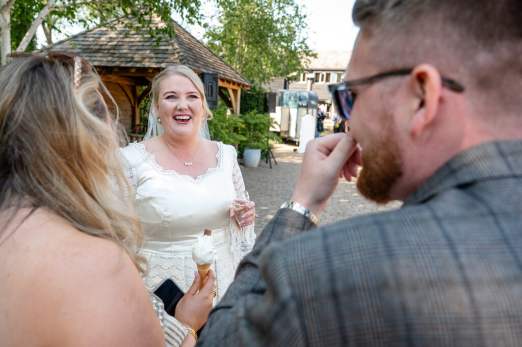 Natural moment of the bride and groom chatting with guests during welcome drinks.