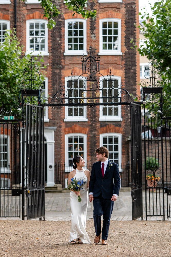 a newly married couple walks arm in arm after their wedding captured by a Watford wedding photographer