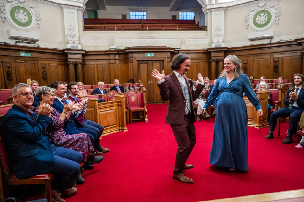 Bride and groom laughing during their Islington Town Hall wedding ceremony