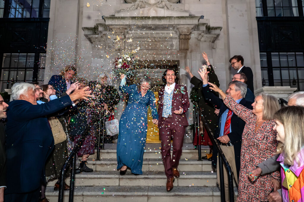 Confetti exit on the steps of Islington Town Hall during a micro wedding in London