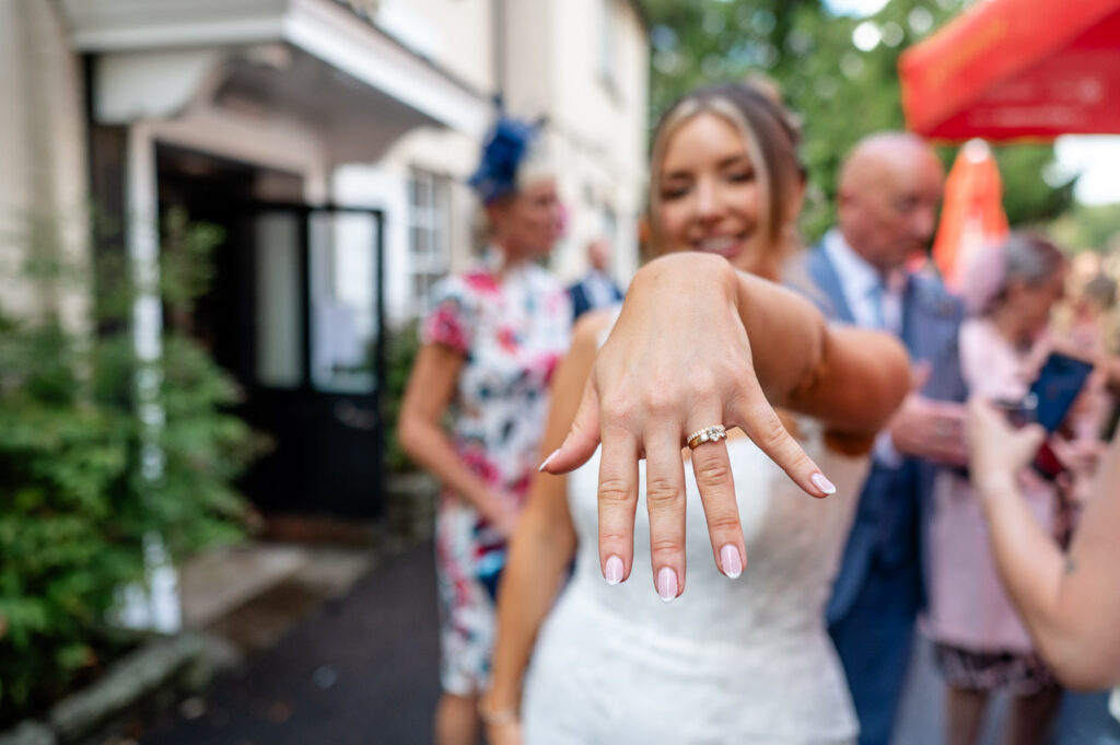 a bride shows off her ring to a watford wedding photographer