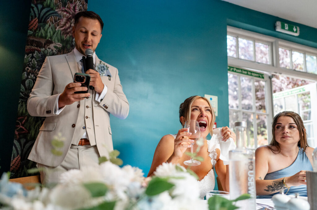 bride laughs and cries during the groom's wedding speech at a Watford wedding
