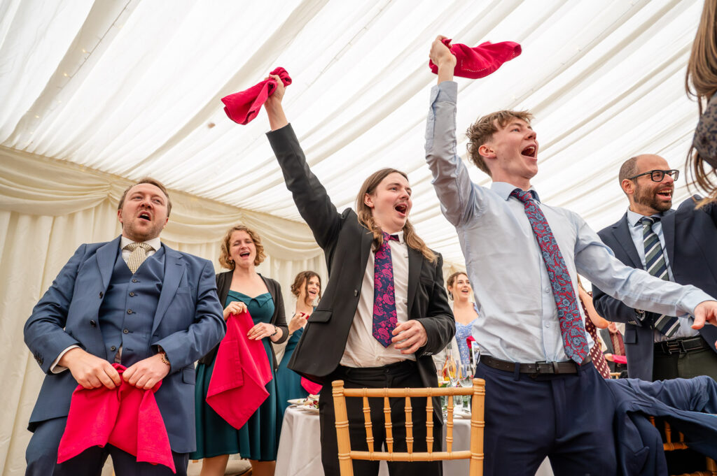 Cheers and napkin waving for the new Mr&Mrs at Chenies Manor Wedding
