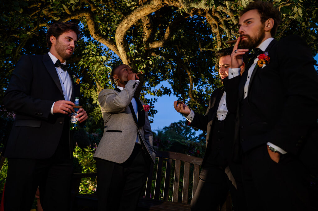 Grooms and best men enjoying a cigar at a Chenies Manor wedding