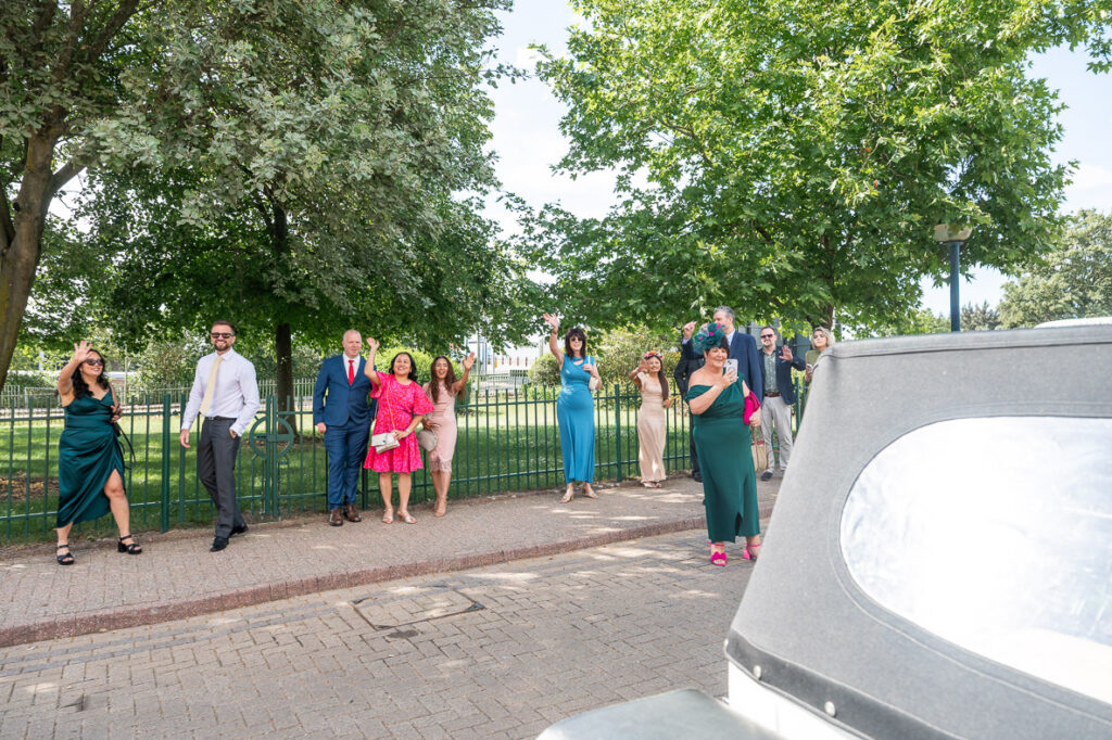 guests waving goodbye to the bride and groom at a St Albans Register Office Wedding by As You Are Photography